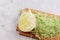 Half of head of the young white cabbage shredded on the wooden cutting board on a light gray background