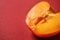 Half of juicy persimmon on color background. Erotic concept