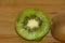 Half kiwi in detail over wood background