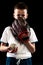 Half-length portrait of kid, beginner baseball player in sports uniform posing with baseball glove isolated on dark