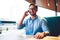 Half length portrait of positive male owner of cafeteria in stylish eyewear