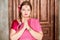 Half-length portrait of woman in pink dress prays