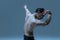 Half-length portrait of young man, flexible male contemp dancer dancing isolated on old navy studio background. Art