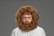 Half-length portrait of young very hairy man isolated over grey background.