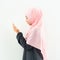 Half length side view of asian young beautiful muslim woman prayer dress hijab pray meditation in mosque for eid mubarak life and