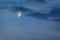 Half Moon glows in blue sky at twilight