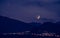 Half moon is rising on the horizon, Mountains and lights