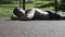 Half naked athlete in shorts lying on his stomach on the ground.