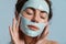 Half-naked european woman posing in cosmetic facial mask