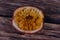 Half of passionfruit lying on wooden table showing seed detail