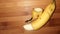 half pealed banana  on brown background closeup image