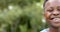 Half portrait of happy african american boy laughing in sunny garden, copy space, slow motion