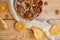 A half of powdered pear pie decorated with white cloth and spoon, dried oranges, walnuts, anise stars and sliced fresh pears