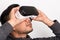 Half profile of young asian man holding virtual reality goggles