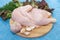 Half raw chicken, Ingredients for cooking, vegetables, garlic on wooden rustic background