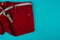 Half of the red shorts close-up with a centimeter instead of a belt on a blue background, next to an empty area.
