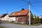 Half renovated small attached suburban street corner family house with two entrances and multiple windows