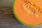 Half of ripe organic cantaloupe melon muskmelon, mushmelon, rockmelon on old wooden table.