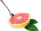 Half ripe organic grapefruit with spoon isolated.