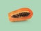 Half of ripe papaya fruit with seeds on a color background. Appetizing tropical fruit