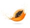 Half of ripe papaya in splashes of fresh juice