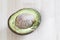 Half rotten avocado on wood background