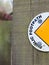 Half of A Sign on A Wood Post Saying Public Footpath with Semi-Circle and Yellow Arrowhead Leading to the Left to the Pathway