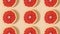 Half sliced citrus grapefruit pattern rotating. Stop motion flat lay