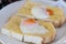 Half soft boiled eggs on toasted bread, popular Chinese breakfast