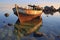 half-submerged boat near rocky shore