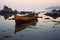 half-submerged boat near rocky shore