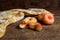 Half and three whole saturn peaches or flat peaches on wooden background with yellow kitchen towel