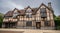 Half-timbered beauty, Shakespeare`s birthplace with cloudy dark skies.