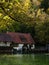 Half-timbered house mill Blautopfhaus at blue turquoise freshwater spring Blautopf in Blaubeuren Baden-Wuerttemberg