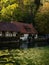 Half-timbered house mill Blautopfhaus at blue turquoise freshwater spring Blautopf in Blaubeuren Baden-Wuerttemberg