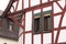 Half-timbered house with red wooden beams amd green windows Germany