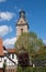 Half timbered house with the tower of the Saint Kilian church in Korbach