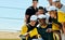 Half time aka selfie time. a team of young baseball players staking a selfie together while standing on the field during