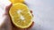 Half of Ugly double organic lemon unusual shape in human hand on grey background with copy space. Buying imperfect