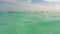 Half underwater, blurry turquoise ocean waves, sandy beach on tropical island, slow motion close up video. Thailand, Bamboo Island