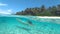 HALF UNDERWATER: Woman on holiday dives in the stunning ocean along sandy beach