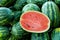 Half watermelon one pice on lot of water melons, Healthy eating. Lots of juicy and ripe watermelons