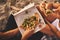 Halfway down our bellies. a young unrecognizable couple having a small picnic date and sharing a pizza on the beach at