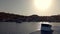 Halki , Greece: A ship leaving an island of Halki  Chalki  during sunset