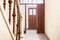 Hall entrance in a old house with a wooden door and stairs