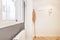 Hall and hallway of a residential apartment with oak parquet floors, a window to an interior patio and industrial-type furniture