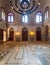 Hall at Mamluk era Sultan al Ghuri Mausoleum with decorated marble floor, stained glass windows, bricks stone wall, Cairo, Egypt