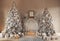 Hall room interior with a fireplace with candles and two decorated Christmas trees with gifts.