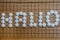 Hallo lettering on the famous Asian board game Go in white