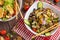 Halloumi salad and beef salad in two separate plates on wooden background